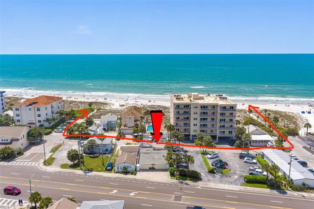 Aerial view: the house marked with a red arrow, with routes from the back gate along the lane to two beach access paths, one to the left and one to the right
